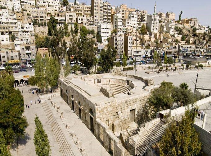 Modern shopping centers alongside historic landmarks in Amman's districts