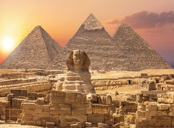 Golden hour light casting warmth over the Giza Plateau pyramids
