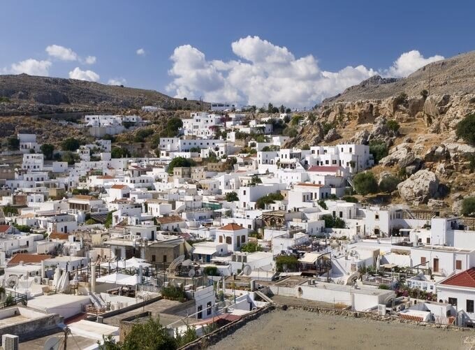  Charming Rhodes alley with blooming flowers and traditional stone buildings